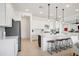 Modern kitchen with large island, stainless steel appliances, stylish pendant lights, and white cabinetry at 15175 S 185Th Ave, Goodyear, AZ 85338