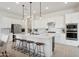 Bright kitchen features a large island with bar seating, stainless steel appliances, and stylish pendant lighting at 15175 S 185Th Ave, Goodyear, AZ 85338
