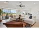 Spacious living room with a sectional sofa and sliding glass doors leading to the patio at 15175 S 185Th Ave, Goodyear, AZ 85338