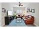 Inviting living room with leather sofas, ceiling fan, and a cozy atmosphere at 15175 S 185Th Ave, Goodyear, AZ 85338