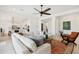 Bright and open living area with a large sectional sofa and views into the kitchen at 15175 S 185Th Ave, Goodyear, AZ 85338