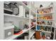 Walk-in pantry boasts abundant shelving for ample storage of food items and kitchen appliances at 15175 S 185Th Ave, Goodyear, AZ 85338