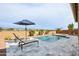 Beautiful pool with sun loungers and desert landscaping creates a relaxing outdoor oasis at 15175 S 185Th Ave, Goodyear, AZ 85338