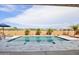 Gorgeous pool with beautiful stonework and an outdoor patio with seating and desert landscaping at 15175 S 185Th Ave, Goodyear, AZ 85338