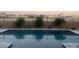 Wide backyard pool with cool blue water, landscaping, and perimeter fencing at 15175 S 185Th Ave, Goodyear, AZ 85338