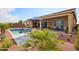 Inviting pool area with desert landscaping, outdoor seating, and a covered patio, perfect for relaxing or entertaining at 15175 S 185Th Ave, Goodyear, AZ 85338