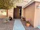 Inviting front entrance with a stone facade and colorful potted plants at 3407 E Glacier Pl, Chandler, AZ 85249