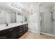 Bathroom with double vanity, soaking tub, and shower at 7351 W Palo Brea Ln, Peoria, AZ 85383