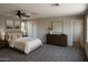 Spacious bedroom featuring neutral decor, ceiling fan, and ample natural light at 7351 W Palo Brea Ln, Peoria, AZ 85383