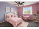 Charming bedroom with pink accents, a plush bed, and a cozy reading nook at 7351 W Palo Brea Ln, Peoria, AZ 85383