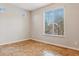 Spacious bedroom with tile floors and large window with blinds at 7351 W Palo Brea Ln, Peoria, AZ 85383