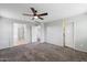 Primary bedroom with carpet and access to bathroom at 7351 W Palo Brea Ln, Peoria, AZ 85383