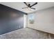 Bedroom with grey and dark blue walls, ceiling fan at 7351 W Palo Brea Ln, Peoria, AZ 85383