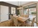Bright dining area with modern light fixture and sliding glass doors to the backyard at 7351 W Palo Brea Ln, Peoria, AZ 85383