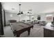 Large game room with a pool table, seating area, and ample natural light at 7351 W Palo Brea Ln, Peoria, AZ 85383