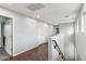 Upstairs hallway with wood floors and doors to bedrooms at 7351 W Palo Brea Ln, Peoria, AZ 85383