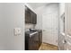 Well-lit laundry room with washer, dryer, and cabinets at 7351 W Palo Brea Ln, Peoria, AZ 85383