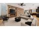 Spacious living room featuring a stone accent wall with fireplace and modern furnishings at 7351 W Palo Brea Ln, Peoria, AZ 85383
