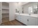 Elegant bathroom with double vanity, large mirror, and walk-in closet at 13567 W Steed Ridge Rd, Peoria, AZ 85383