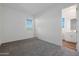 Well-lit bedroom with gray carpeting and en-suite bathroom at 13567 W Steed Ridge Rd, Peoria, AZ 85383