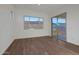 Room with wood-look flooring and sliding glass door to backyard at 13567 W Steed Ridge Rd, Peoria, AZ 85383