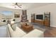 Living room showcasing a corner fireplace and modern entertainment center at 323 W Quartz Rock Rd, Phoenix, AZ 85085