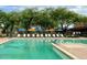 Inviting community pool with lounge chairs and umbrellas at 2425 W Bronco Butte Trl # 2017, Phoenix, AZ 85085