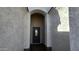 Elegant entryway with arched detail and a dark brown door at 3915 N Juniper Dr, Eloy, AZ 85131