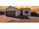 Front view of house with brown garage door and driveway at 3915 N Juniper Dr, Eloy, AZ 85131