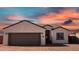 Front view of house with brown garage door and driveway at 3915 N Juniper Dr, Eloy, AZ 85131