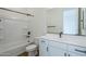 Clean bathroom with white vanity, tub, and black accents at 18956 W Ocotillo Rd, Waddell, AZ 85355