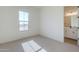 Well-lit bedroom with window and adjacent bathroom access at 18956 W Ocotillo Rd, Waddell, AZ 85355