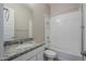 Well-lit bathroom with granite vanity, bathtub, and tiled shower at 19020 W Ocotillo Rd, Waddell, AZ 85355