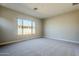 Bright bedroom with carpet and backyard view at 19020 W Ocotillo Rd, Waddell, AZ 85355