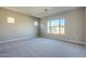 Spacious bedroom with carpet and large window at 19020 W Ocotillo Rd, Waddell, AZ 85355