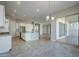 Open concept kitchen with island, breakfast nook, and access to backyard at 19020 W Ocotillo Rd, Waddell, AZ 85355