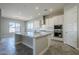 Modern kitchen with granite countertops, white cabinets, and a large island at 19020 W Ocotillo Rd, Waddell, AZ 85355