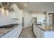 Bright kitchen with white cabinets, granite countertops, and stainless steel appliances at 19020 W Ocotillo Rd, Waddell, AZ 85355