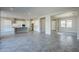 Open living room with tile floors and views into kitchen and dining areas at 19020 W Ocotillo Rd, Waddell, AZ 85355