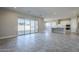 Spacious living area with tile floors and sliding glass doors to patio at 19020 W Ocotillo Rd, Waddell, AZ 85355