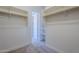Large walk-in closet with built-in shelving and access to bathroom at 19020 W Ocotillo Rd, Waddell, AZ 85355