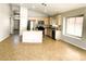 Spacious open floorplan integrating a modern kitchen with stainless appliances and tile floors at 745 E Megan St, Chandler, AZ 85225