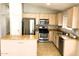 Contemporary kitchen with stainless steel appliances, a center island, and ample cabinet space at 745 E Megan St, Chandler, AZ 85225