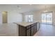 Modern kitchen with island, dark cabinetry, and white quartz countertops at 242 S 165Th Ave, Goodyear, AZ 85338