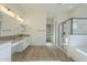 Modern bathroom with double vanity, soaking tub, and glass shower at 260 S 165Th Ave, Goodyear, AZ 85338