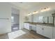 Double vanity bathroom with modern light fixtures at 260 S 165Th Ave, Goodyear, AZ 85338