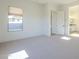Bedroom with window, carpet, and access to bathroom at 260 S 165Th Ave, Goodyear, AZ 85338