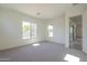 Bright bedroom with window and access to hallway at 260 S 165Th Ave, Goodyear, AZ 85338