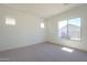 Spacious bedroom with large window and neutral carpeting at 260 S 165Th Ave, Goodyear, AZ 85338