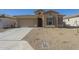 Single-story home with a two-car garage and desert landscaping at 260 S 165Th Ave, Goodyear, AZ 85338